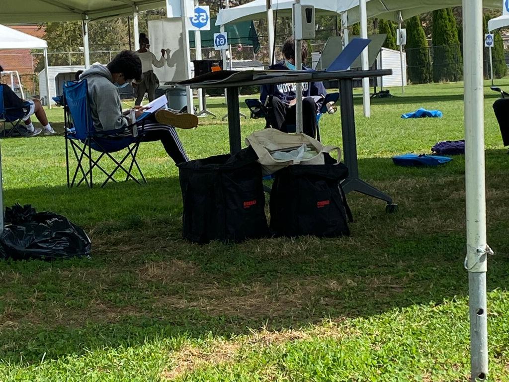 Boys studying under tent by Josiah Bartholomew23