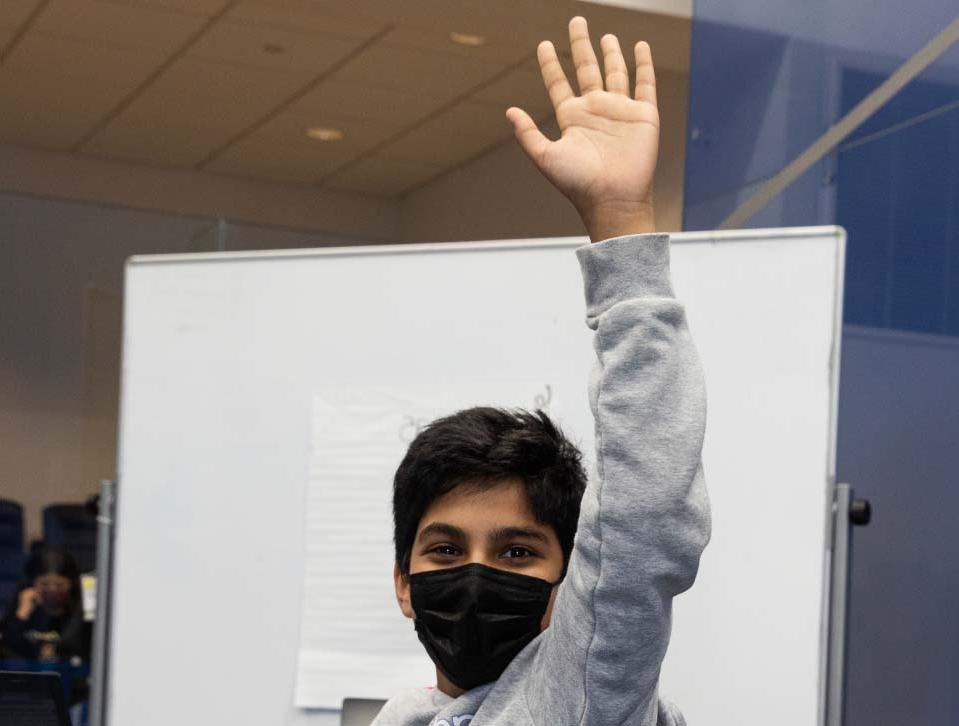 Masked Student raising hand