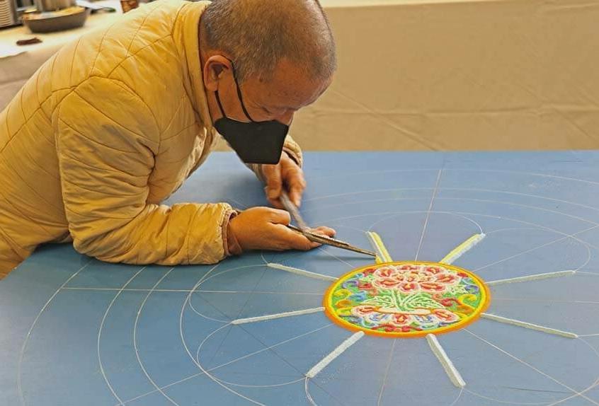 Lama Tenzin works on mandala