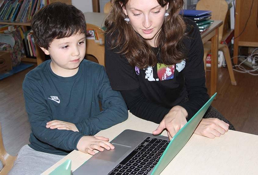 Lower School After School play - child, teacher with computer