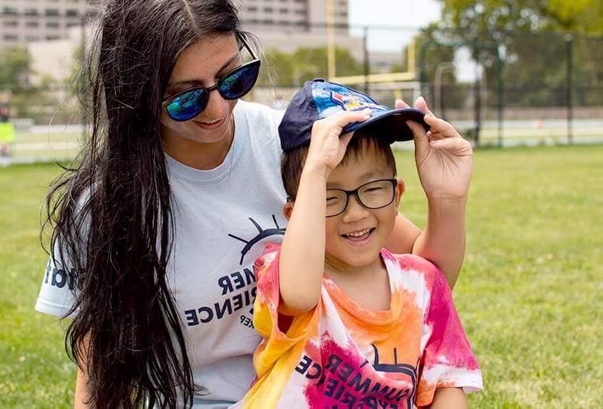 Smiling counselor with kid at Poly Summer day camp