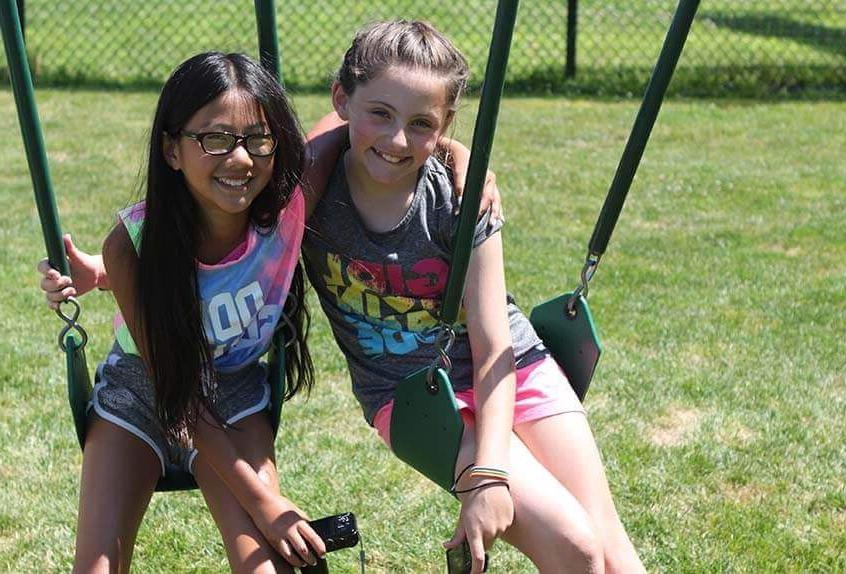 Friends on swings at Poly Summer day camp