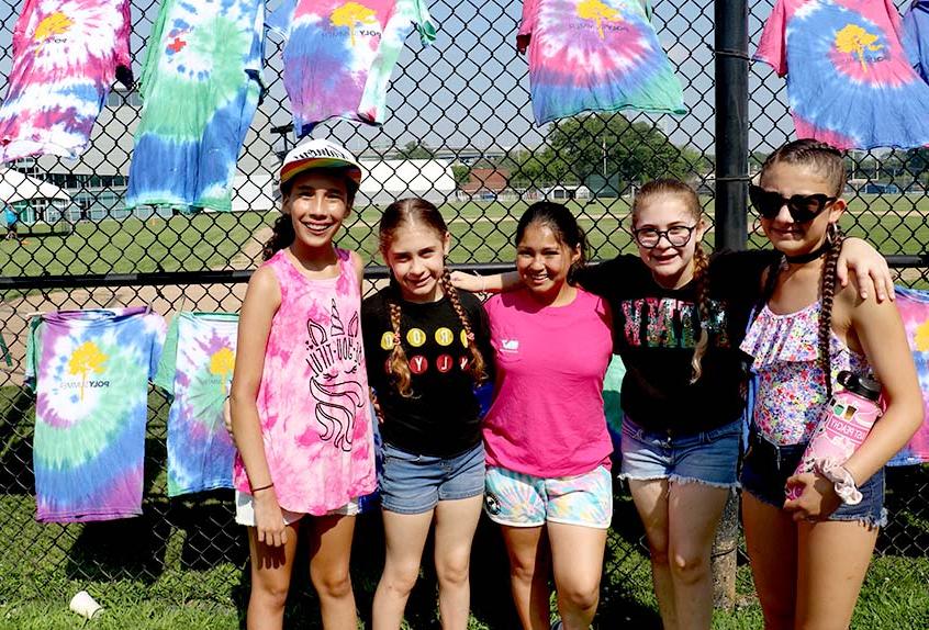 Kids smiling with tie dye shirts at Poly Summer day camp